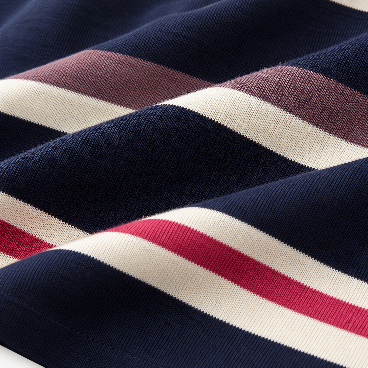 Close-up of the navy cotton-blend knit texture with cream, pink and mauve horizontal stripes.
