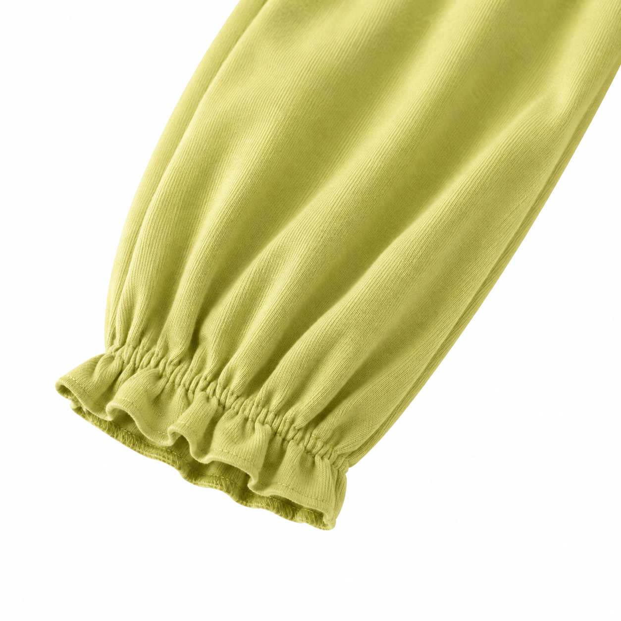 Close-up of the gathered cuff detail on the green pants.