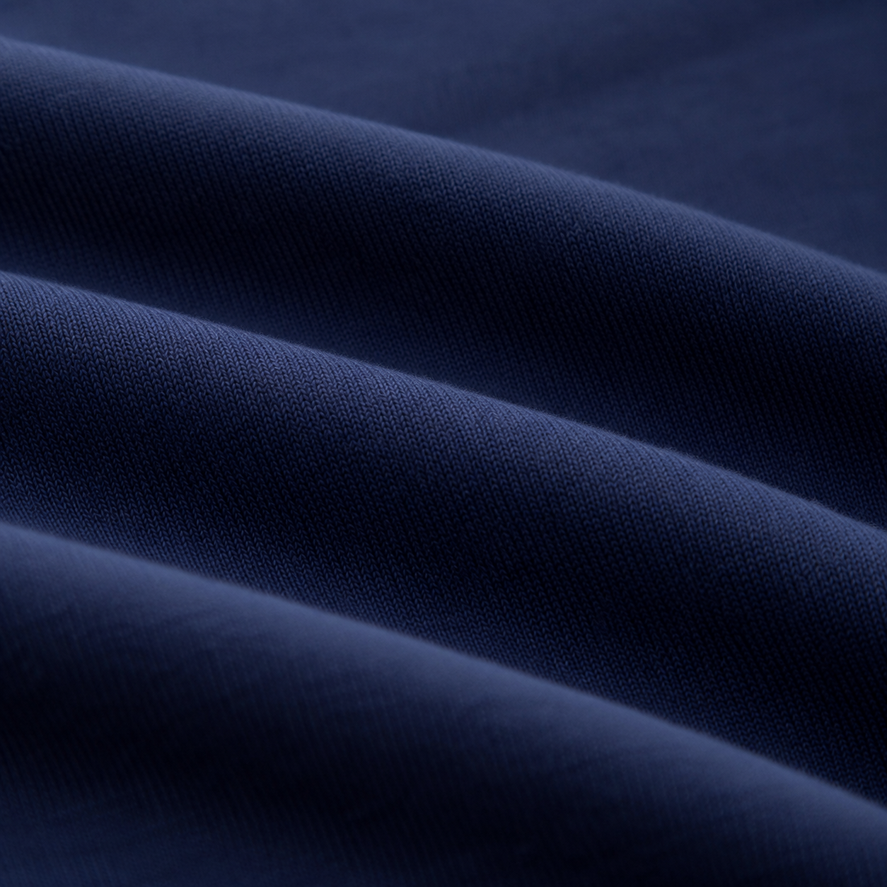 Close-up of the navy cotton blend fabric texture on the girls long sleeve dress.