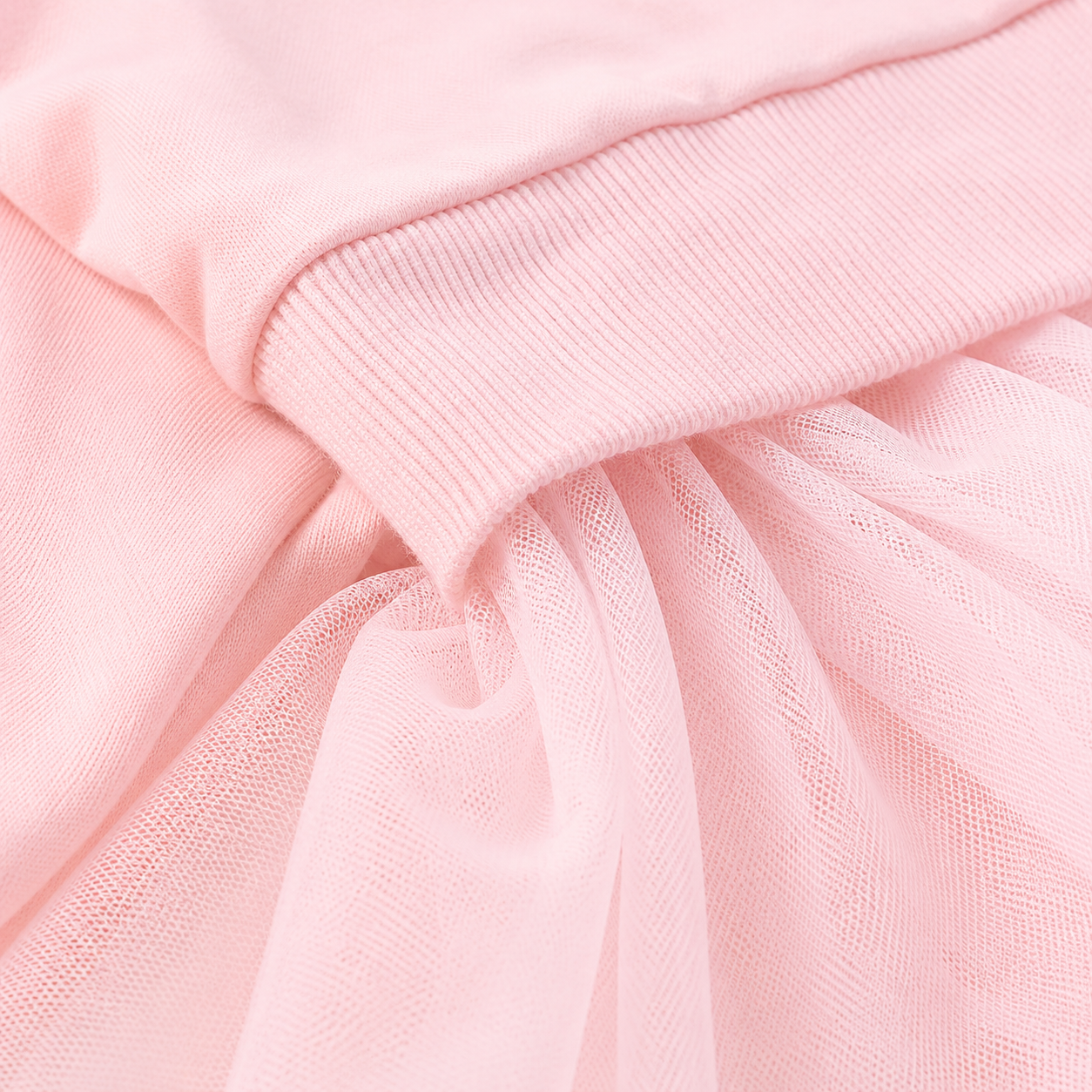 Close-up of the cotton fabric and tulle texture on a pink girls dress.