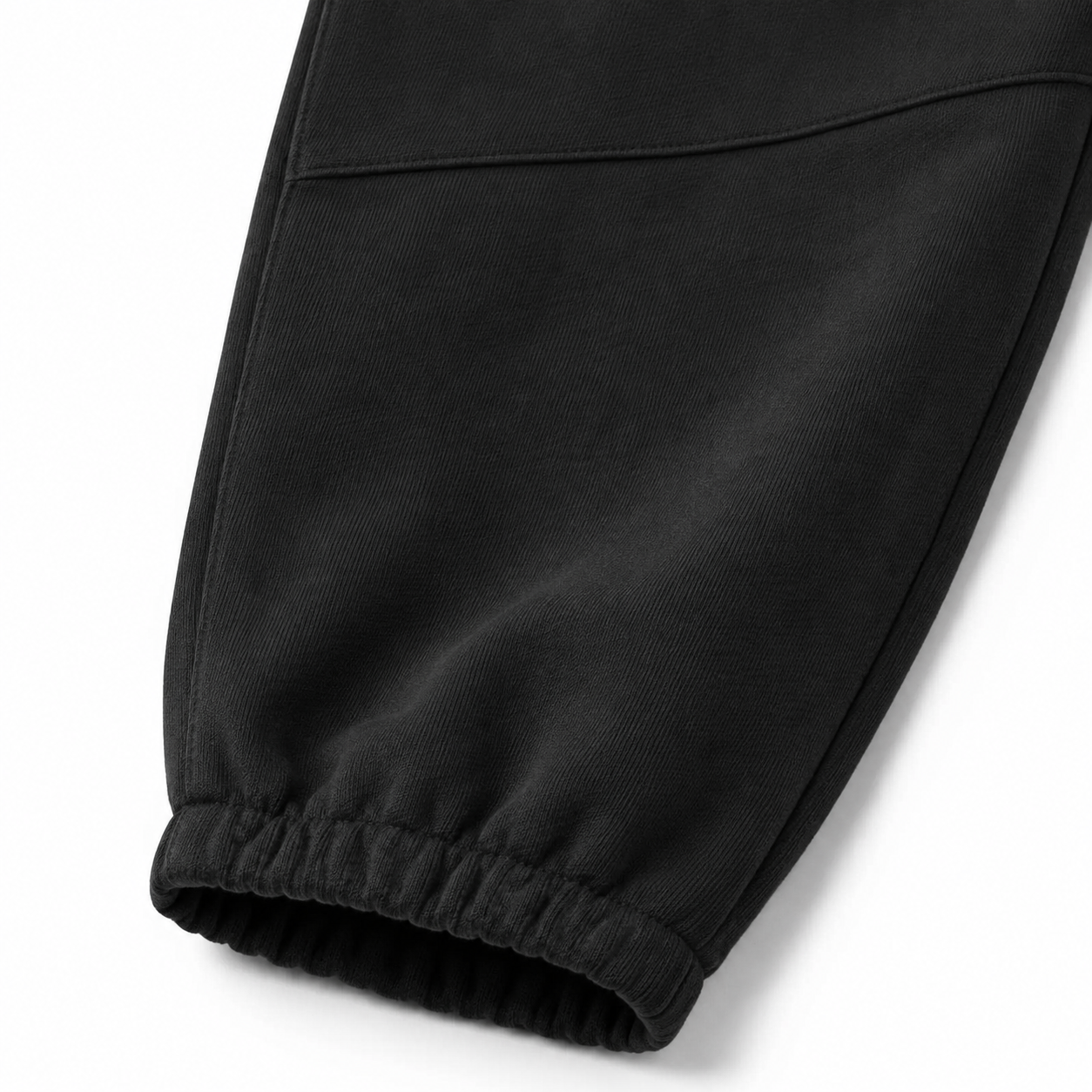 Close-up of the elastic cuff and knee seam detail on the black kids jogger pants.
