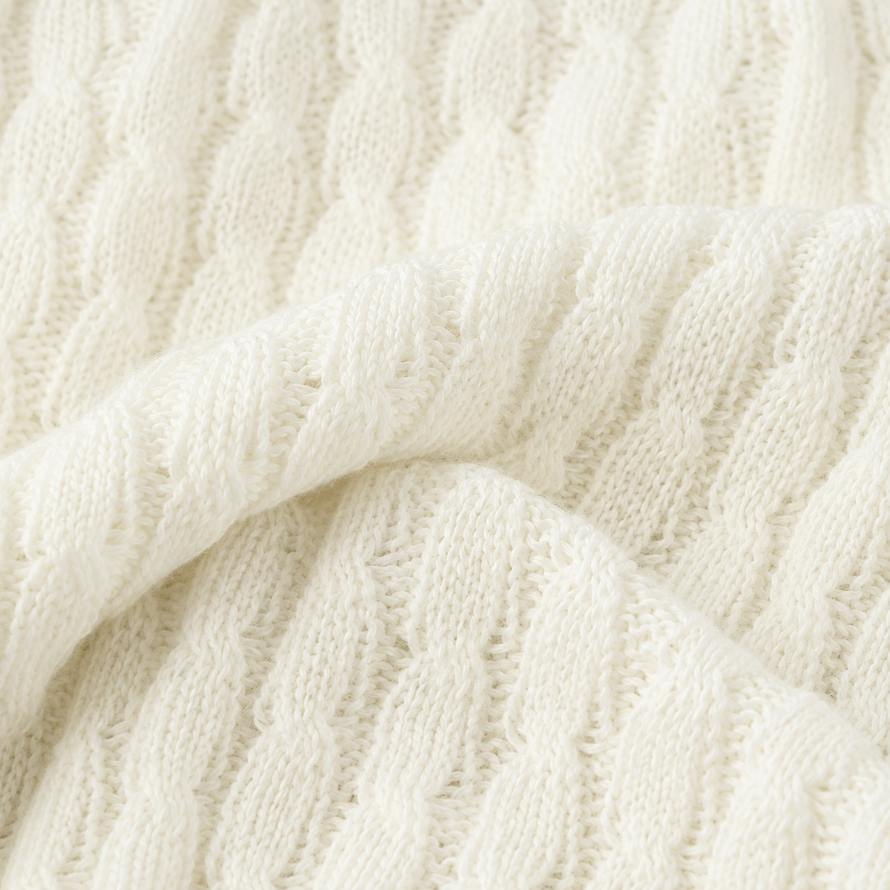 Macro detail of the ivory textured knit fabric used in the girls short sleeve top.
