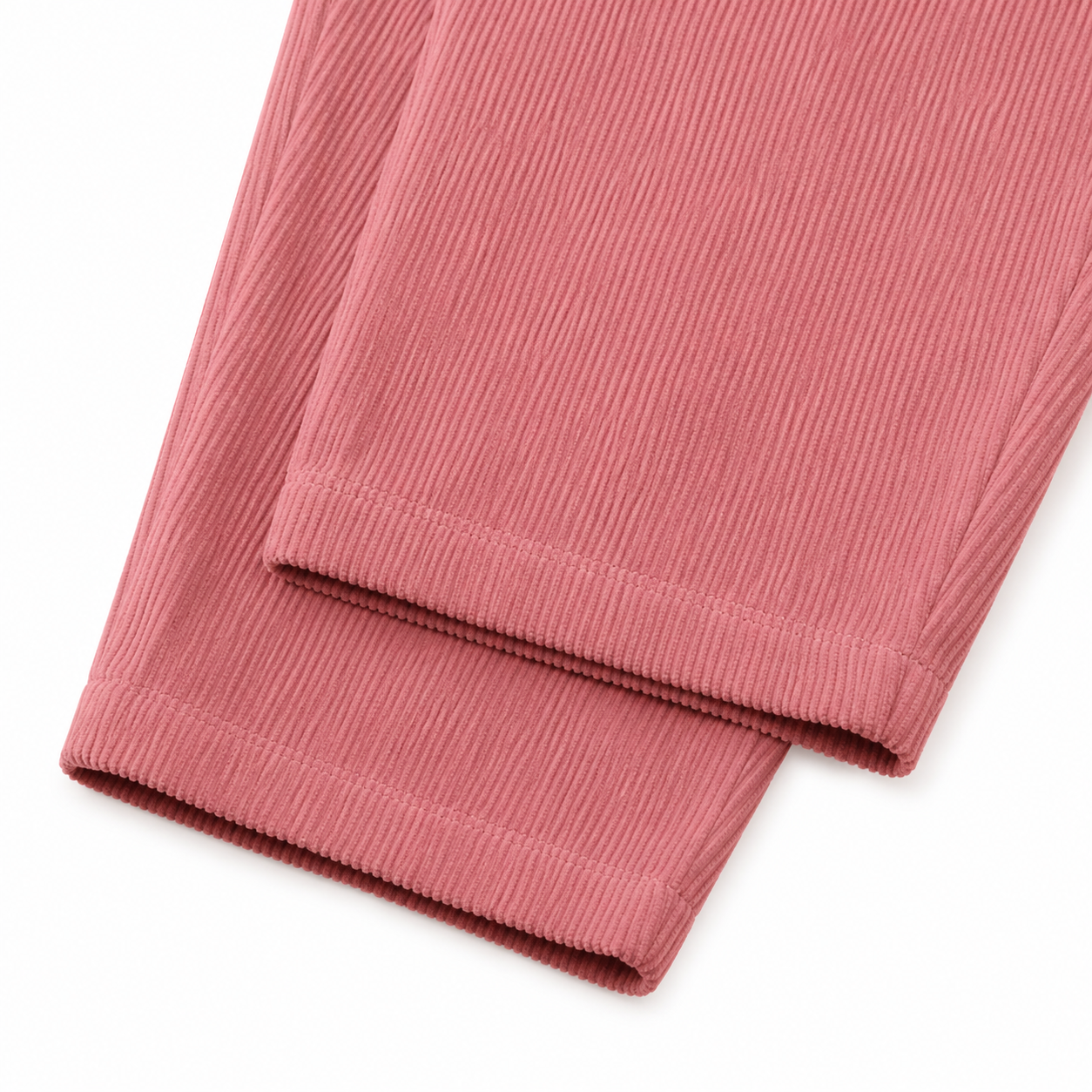 Close-up of the corduroy texture and pant leg hem on the dusty rose overalls.