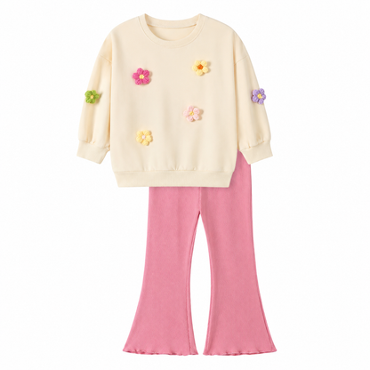 Front flat lay of a girls cotton lounge set with a cream flower applique top and pink flare pants.