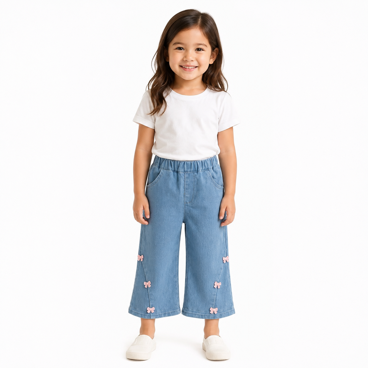 Girl wearing light blue wide leg jeans on a white background