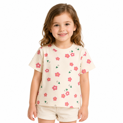 Girl model wearing a cream floral cotton t shirt on a white studio background.