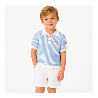 Boy wearing a blue striped knit polo and white shorts set on a white studio background.