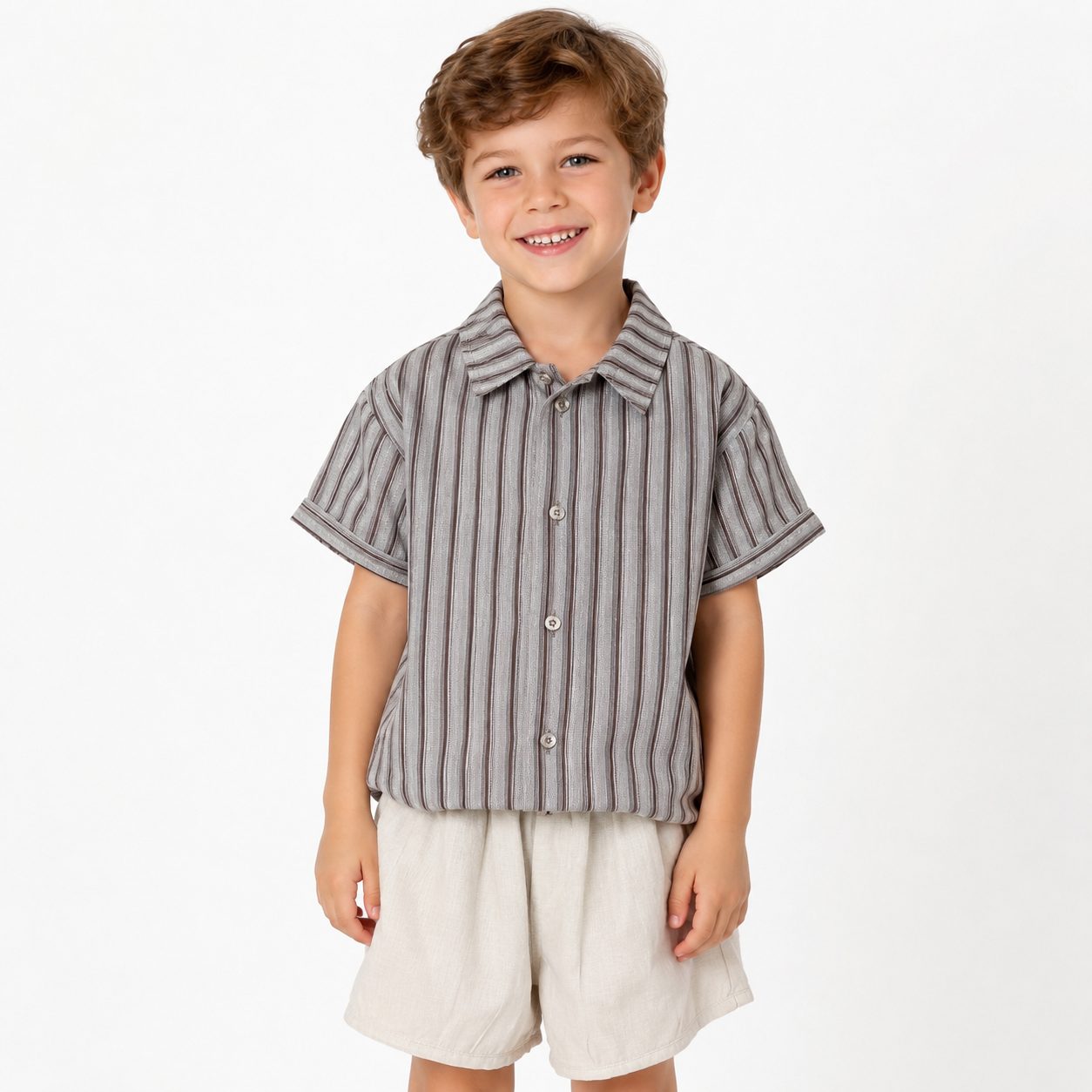 Boy model wearing striped boys shirt and shorts set on a white background.