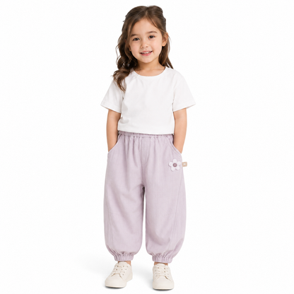 Girl wearing purple balloon pants on a white background