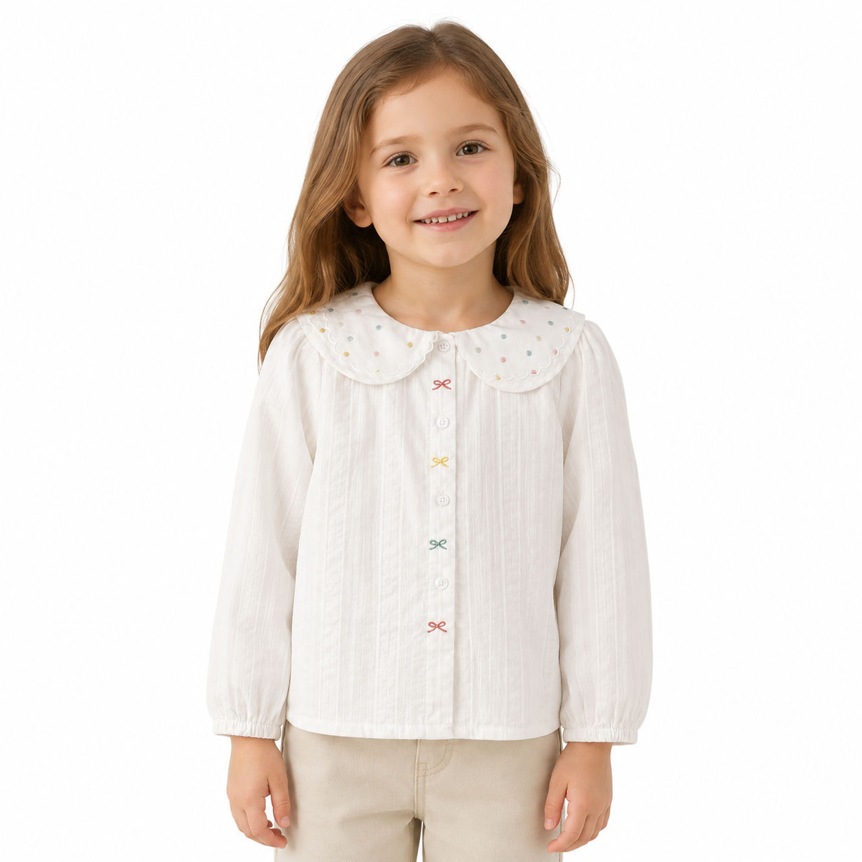 Girl model wearing a white long sleeve cotton blouse with a scalloped dotted collar on a white studio background.