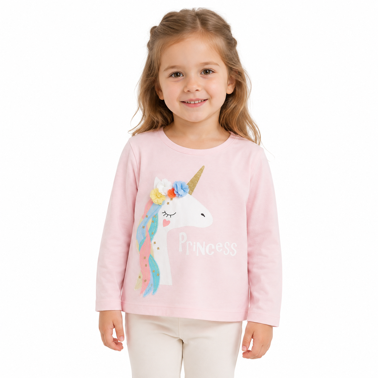 Girl model wearing a pink long sleeve unicorn cotton top on a white studio background.