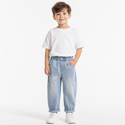 Child model wearing light blue boys denim joggers on a white studio background.