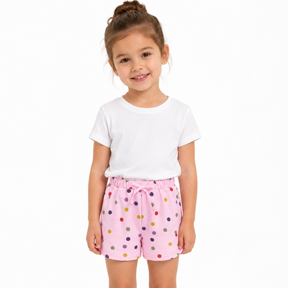 Girl model wearing pink cotton shorts on a clean studio background.