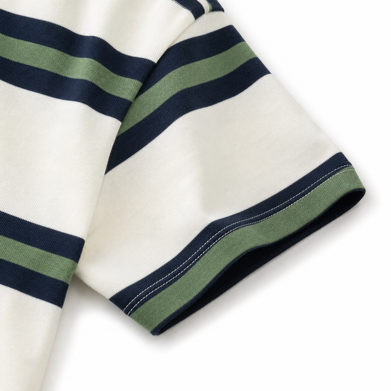 Close-up of the short sleeve hem and navy-green stripe detail on the white T-shirt.