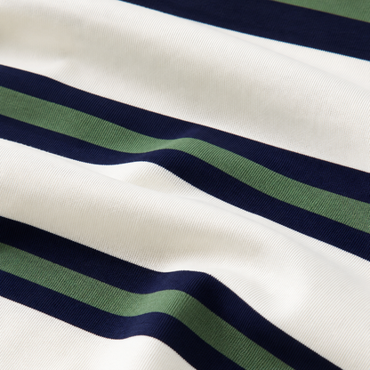 Close-up of the white cotton-blend knit fabric with navy and green horizontal stripes.