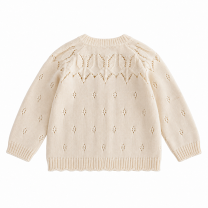 Back view of the cream girls cotton cardigan with openwork leaf-knit shoulders and small eyelet details.