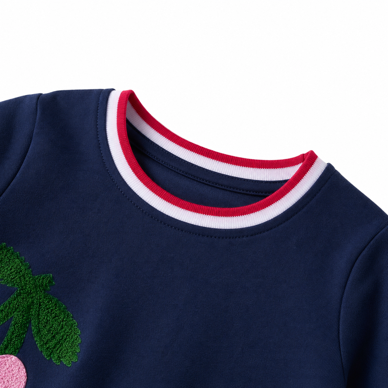 Close-up of the red and white contrast neckline on the navy girls cotton blend dress.