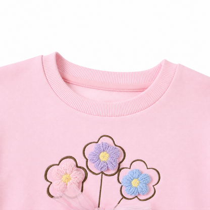 Close-up of neckline detail on the girls cotton dress.