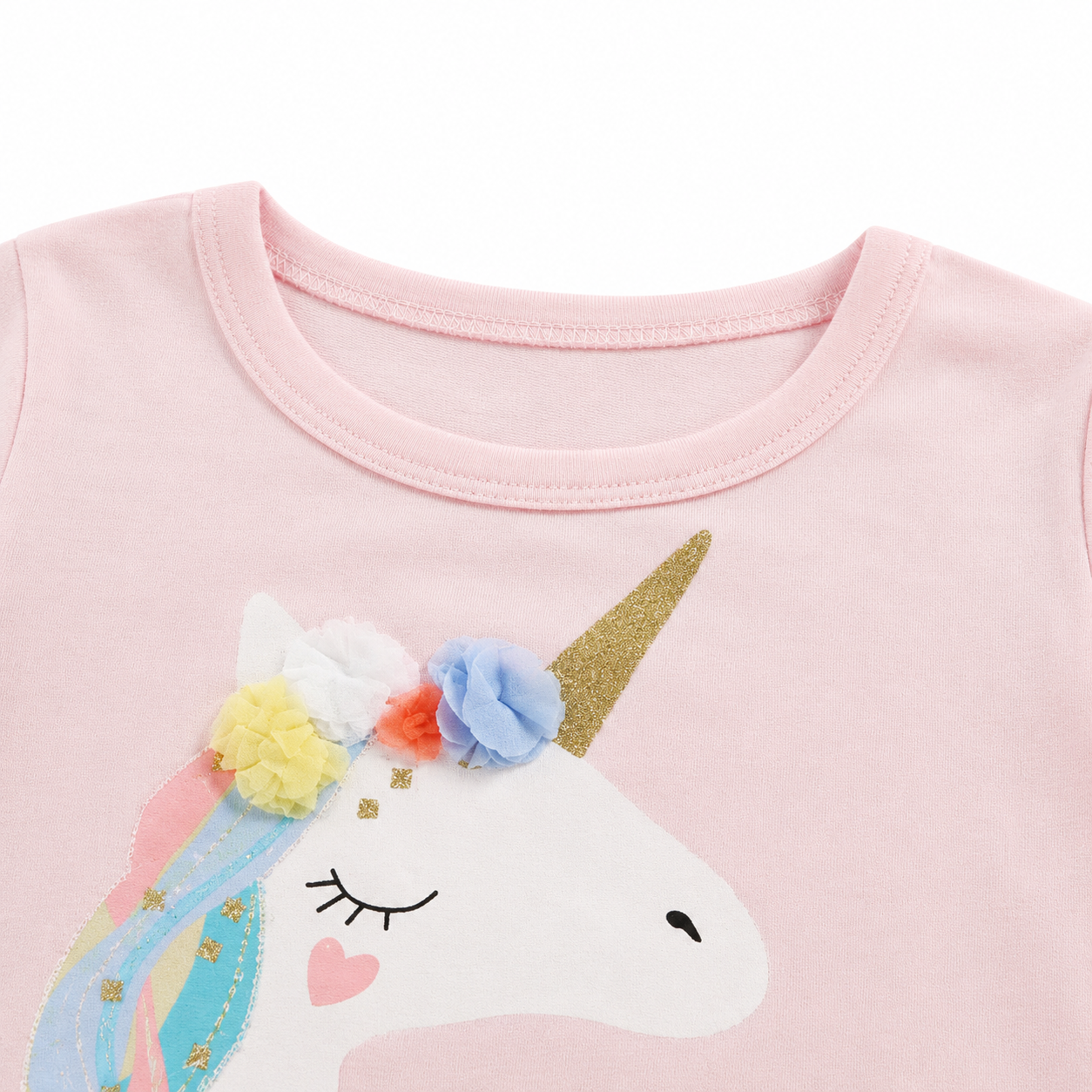 Close-up of the neckline and upper unicorn detail on a pink girls cotton top.