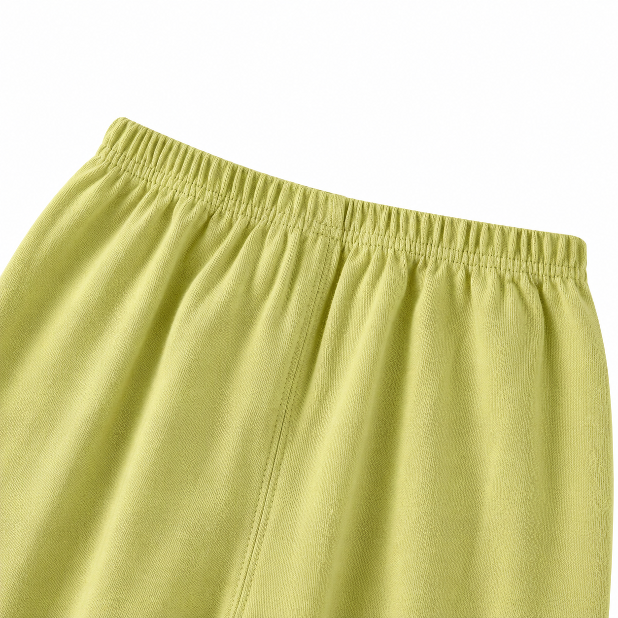 Close-up of the elastic waist detail on the green pants.