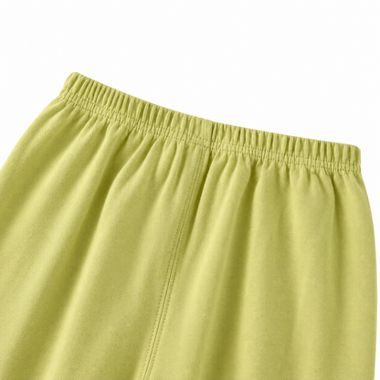 Close-up of the elastic waist detail on the green pants.