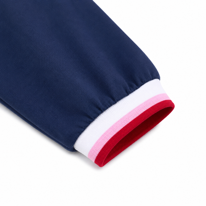 Close-up of the contrast cuff detail on the navy girls long sleeve dress.