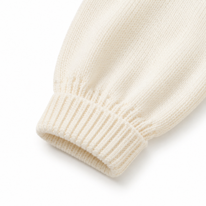 Close-up of the long sleeve and ribbed cuff on the cream girls cotton knit cardigan.