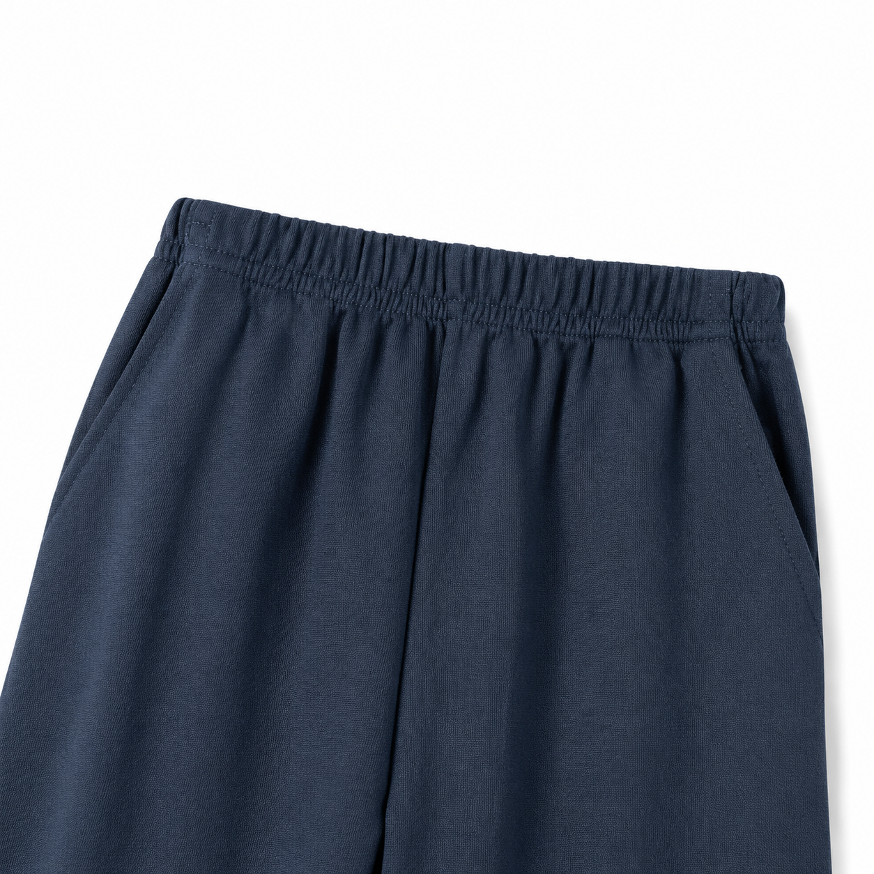 Close-up of the elastic waistband detail on the navy pants.