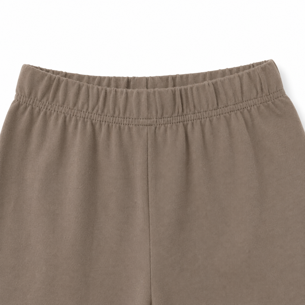 Close-up of the elastic waistband on the taupe pants from the girls cotton set.