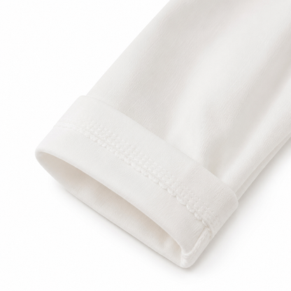 Close-up of the sleeve cuff detail on a white girls cotton top.