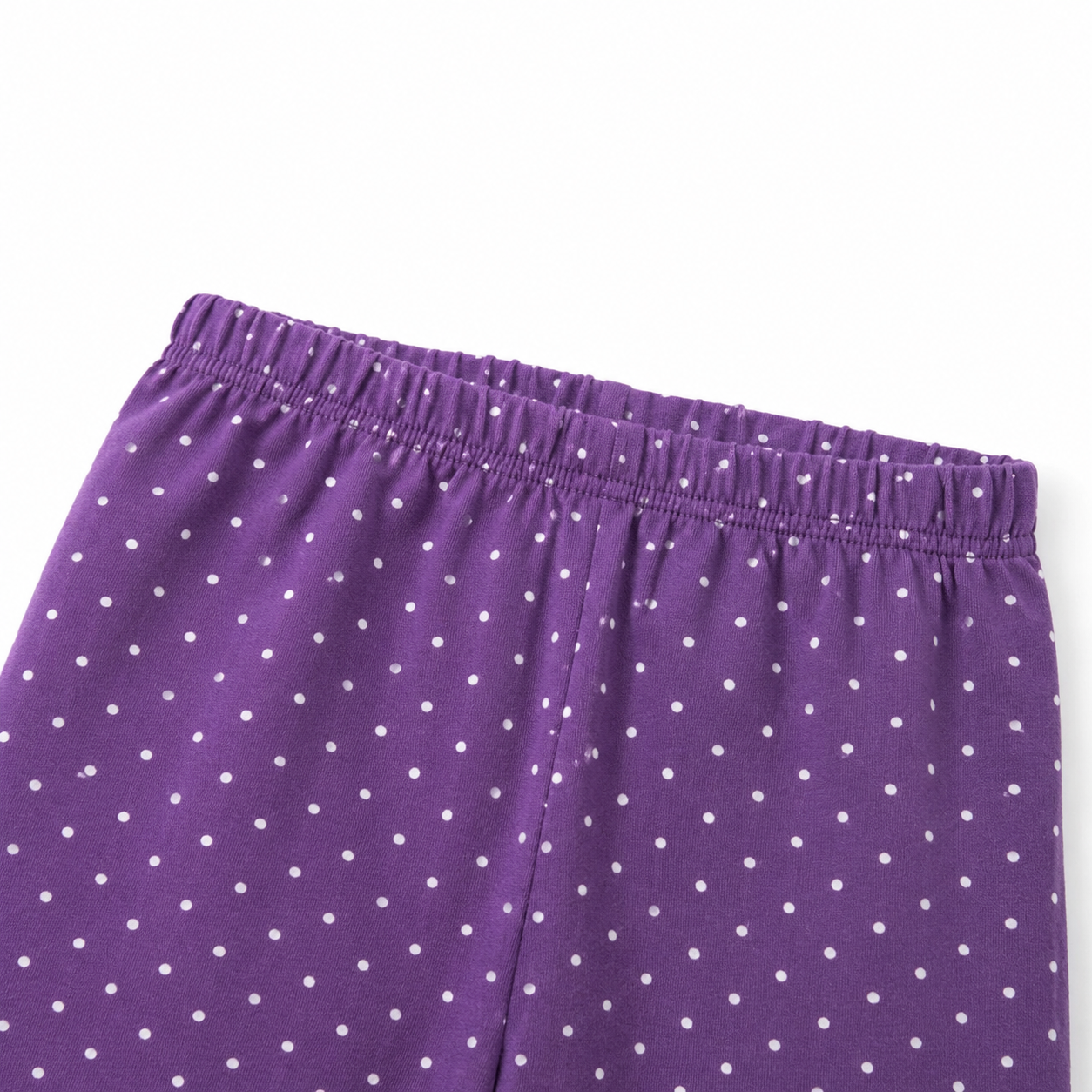 Close-up of the elastic waistband and white polka-dot pattern on the purple pants.