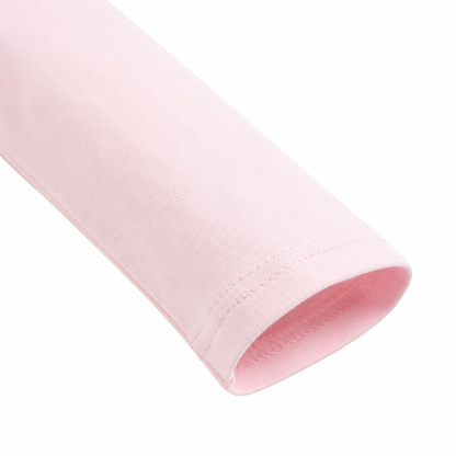 Close-up of the sleeve hem detail on a pink girls long sleeve top.