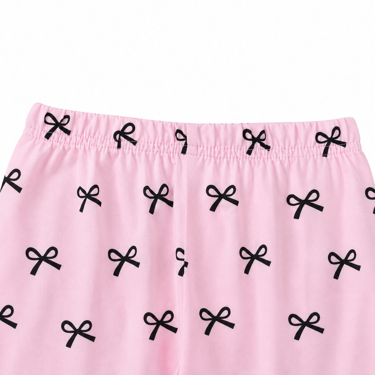 Close-up of the elastic waist detail on the pink printed pants.