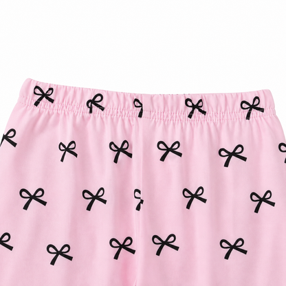 Close-up of the elastic waist detail on the pink printed pants.