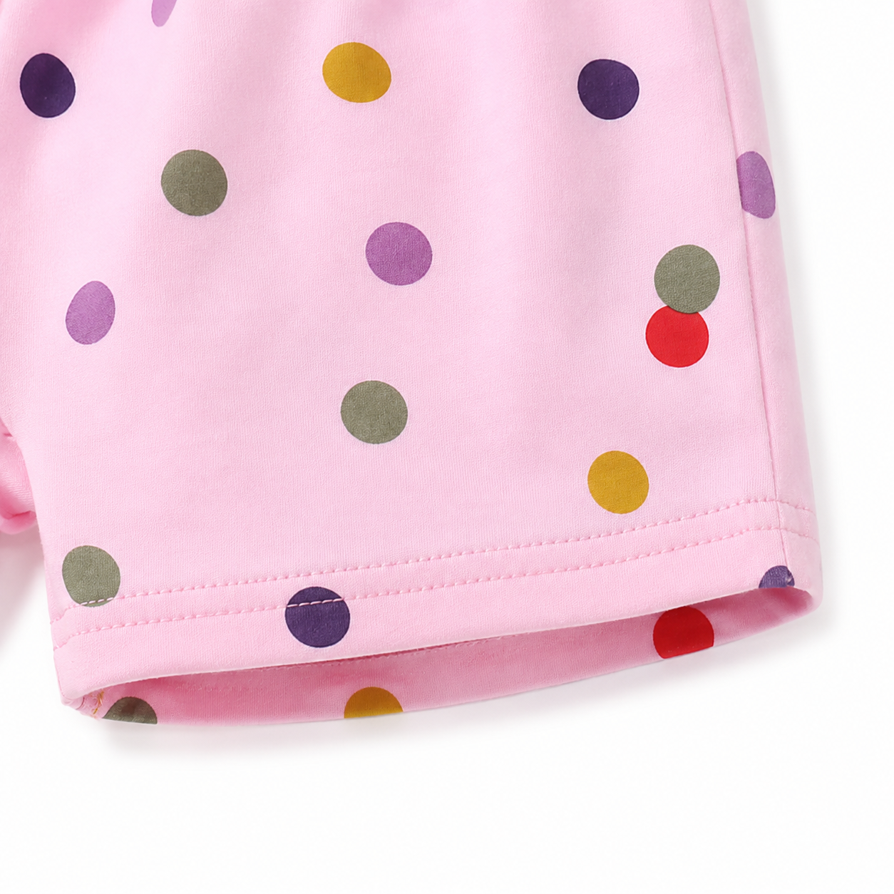 Close-up of hem stitching detail on pink cotton shorts.