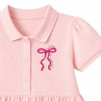 Pink bow embroidery detail on girls polo dress