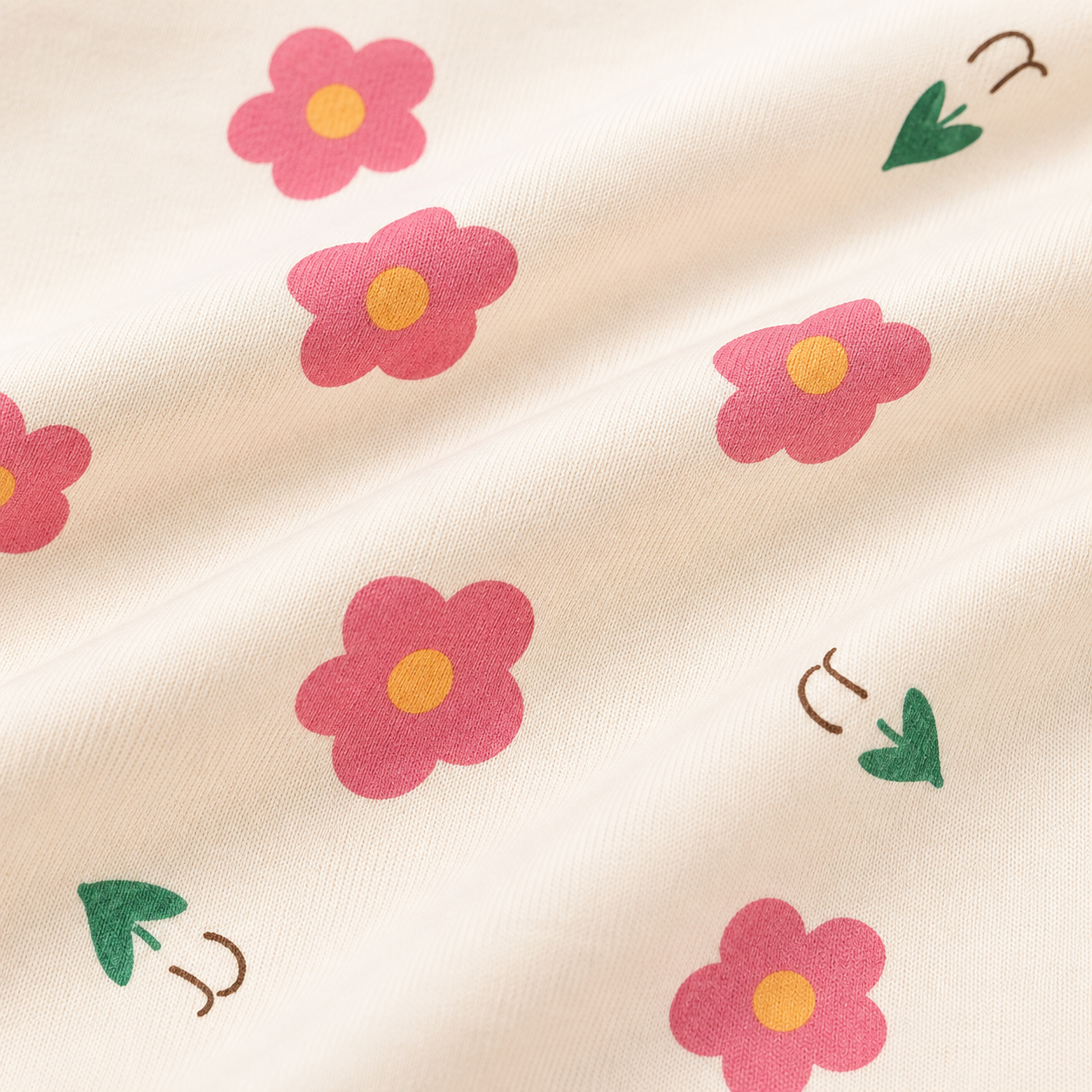 Close-up of the pink flower print detail on a girls cotton t shirt.