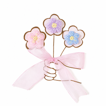 Close-up of flower and bow decoration on the girls cotton dress.