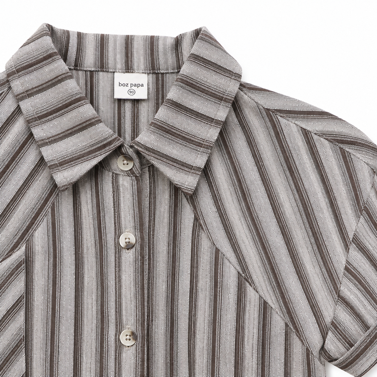 Stripe and button detail of boys short sleeve collared shirt.