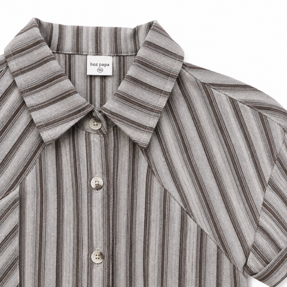 Stripe and button detail of boys short sleeve collared shirt.