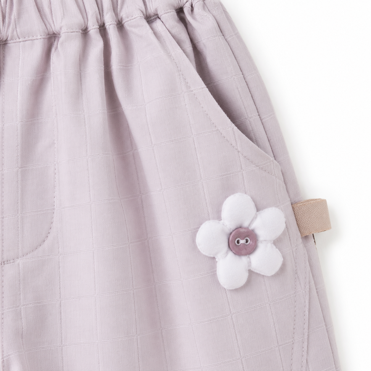 Purple girls pants flower appliqué detail near pocket