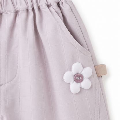 Purple girls pants flower appliqué detail near pocket