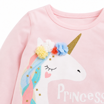 Close-up of the unicorn graphic and floral applique detail on the front of the girls top.