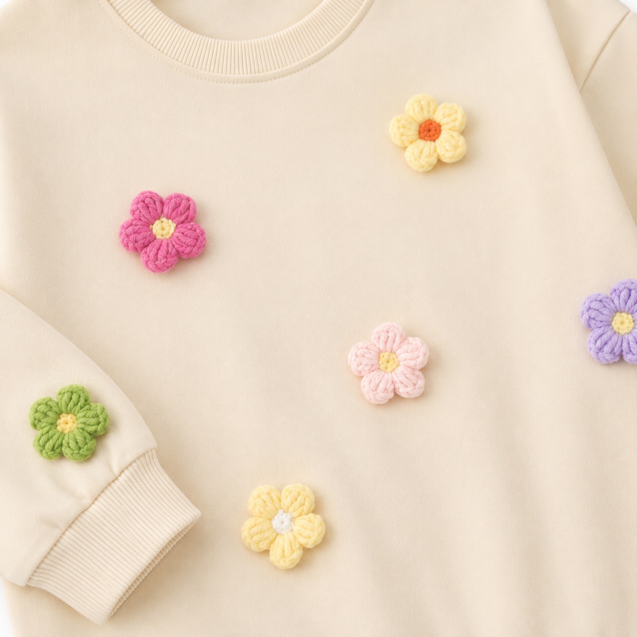 Close-up of the colorful flower applique detail on the girls cotton set.