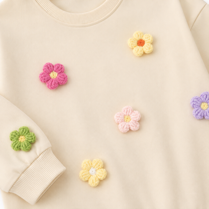 Close-up of the colorful flower applique detail on the girls cotton set.