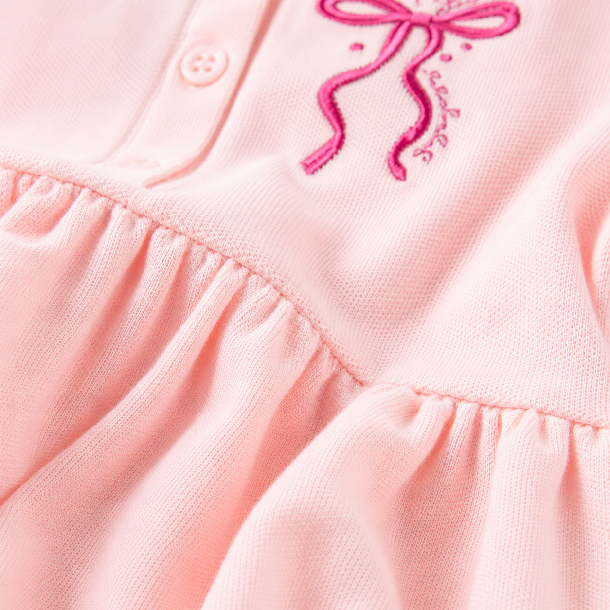 Pink cotton fabric detail of girls polo dress