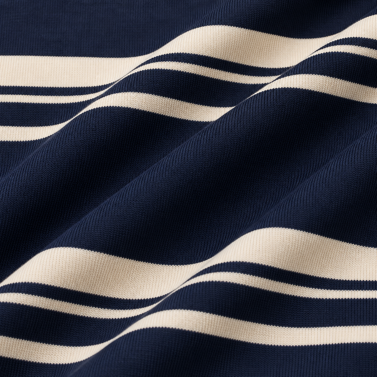 Close-up of the striped fabric texture on a navy girls polo shirt.