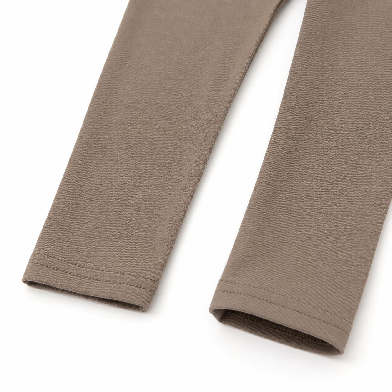 Close-up of the taupe pants hem and stitching detail from the girls cotton two piece set.