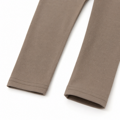 Close-up of the taupe pants hem and stitching detail from the girls cotton two piece set.