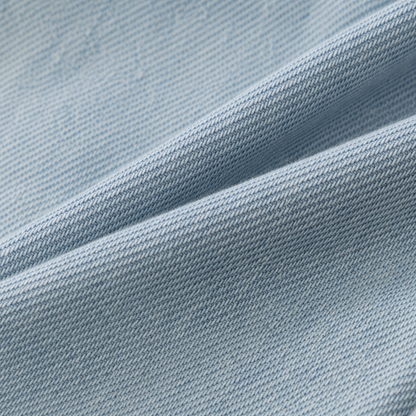 Close-up of soft light blue denim fabric texture.